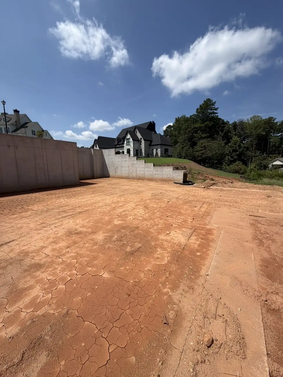 Finished graded pad behind retaining walls